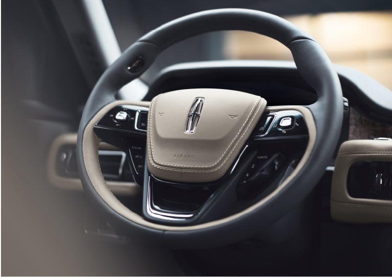 The intuitively placed controls of the steering wheel on a 2023 Lincoln Aviator® SUV | Empire Lincoln of Huntington in Huntington NY