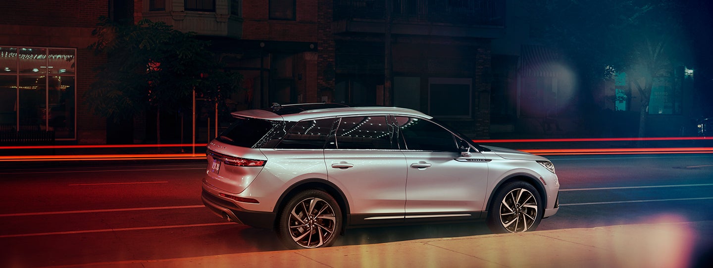 The 2024 Lincoln Corsair® SUV is parked on a city street at night. | Empire Lincoln of Huntington in Huntington NY