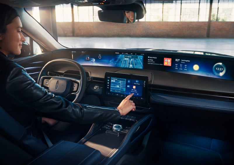 The driver of a 2024 Lincoln Nautilus® SUV interacts with the center touchscreen. | Empire Lincoln of Huntington in Huntington NY