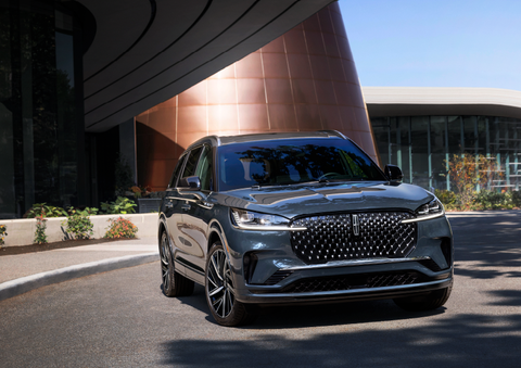 A gray 2025 Lincoln Aviator® SUV is parked outside a modern building with the sun shining. | Empire Lincoln of Huntington in Huntington NY