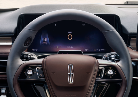 The steering wheel of 2025 Lincoln Aviator® SUV is shown with black and brown accents. | Empire Lincoln of Huntington in Huntington NY