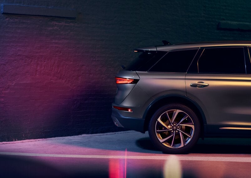 A dramatization of a 2025 Lincoln Corsair® SUV is shown backing up toward a wall. | Empire Lincoln of Huntington in Huntington NY