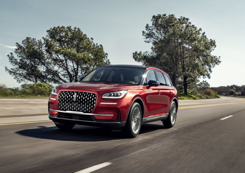 A 2025 Lincoln Corsair® SUV is shown being driven on a country road. | Empire Lincoln of Huntington in Huntington NY