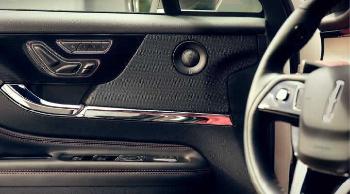 A Revel® audio speaker is shown in the driver's side door of a 2025 Lincoln Corsair® SUV. | Empire Lincoln of Huntington in Huntington NY