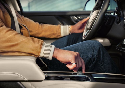 The driver of a 2024 Lincoln Corsair® SUV is shown selecting the drive mode. | Empire Lincoln of Huntington in Huntington NY