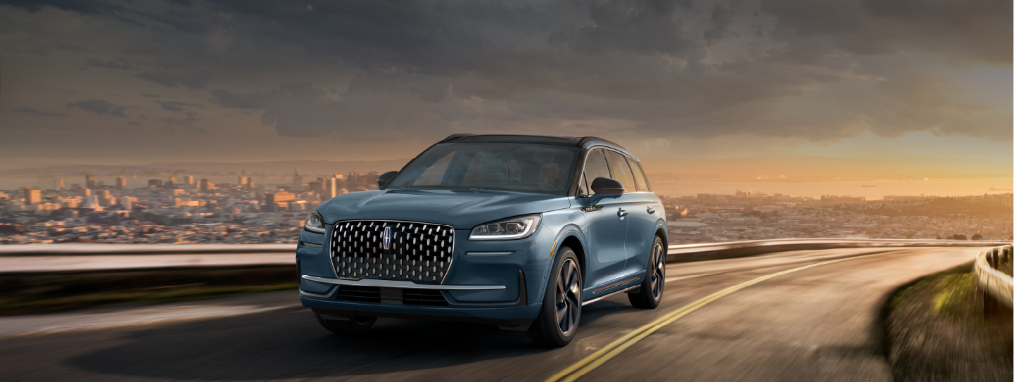 A 2025 Lincoln Corsair® Grand Touring SUV is being driven on a hillside road.