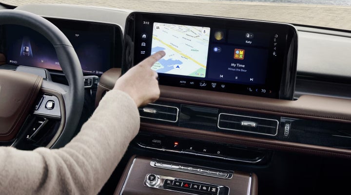 A person is tapping the center display touchscreen of a 2026 Lincoln Aviator® SUV. | Empire Lincoln of Huntington in Huntington NY