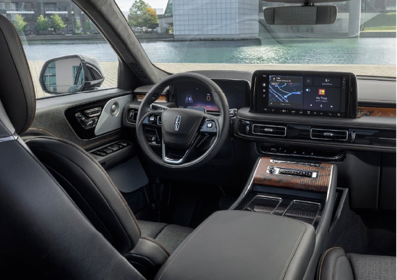 The interior of the 2026 Lincoln Aviator® SUV is shown parked with a view of a harbor through the windshield. | Empire Lincoln of Huntington in Huntington NY