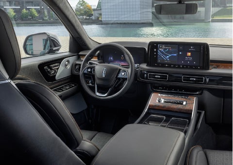 The interior of the 2026 Lincoln Aviator® SUV is shown parked with a view of a harbor through the windshield. | Empire Lincoln of Huntington in Huntington NY