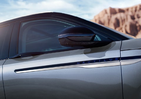 Blue lettering on the side of the vehicle that reads Nautilus indicates the available Hybrid Powertrain. | Empire Lincoln of Huntington in Huntington NY