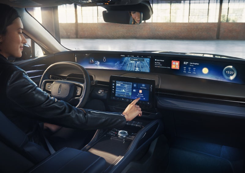 The driver of a 2026 Lincoln Nautilus® SUV interacts with the center touchscreen. | Empire Lincoln of Huntington in Huntington NY