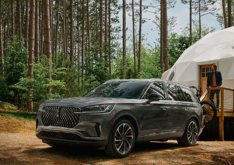 A 2027 Lincoln Aviator® is parked next to a high end glamping site. | Empire Lincoln of Huntington in Huntington NY