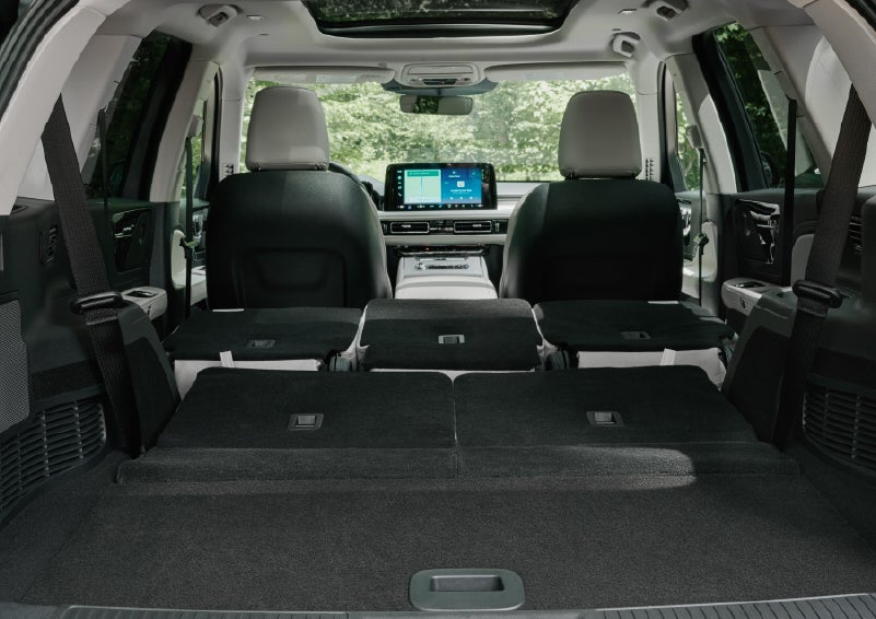 A rear to front view of the interior of a 2027 Lincoln Aviator® Black Label™ SUV shows the third and second rows folded flat | Empire Lincoln of Huntington in Huntington NY