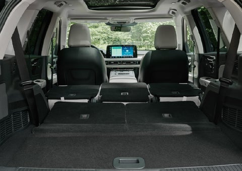 A rear to front view of the interior of a 2027 Lincoln Aviator® Black Label™ SUV shows the third and second rows folded flat | Empire Lincoln of Huntington in Huntington NY